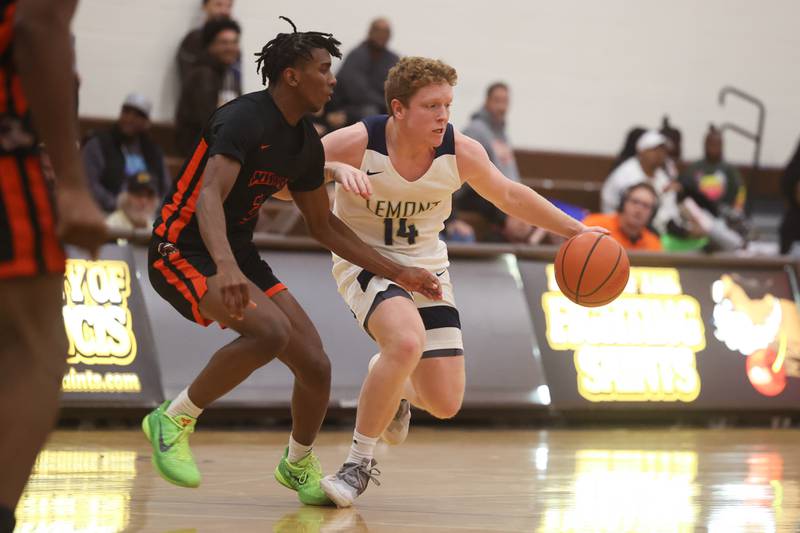 Lemont’s Conor Murry works the ball at the top of the key against Romeoville in the WJOL Thanksgiving Classic Championship in Joliet on Saturday.
