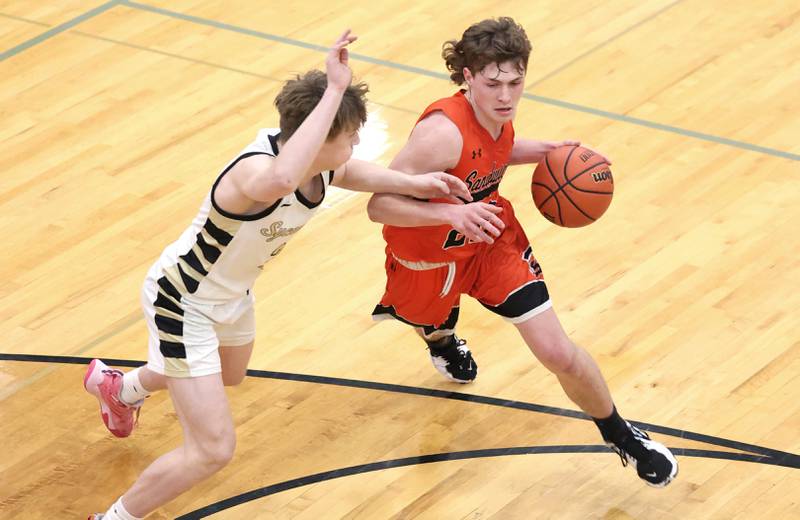 Sandwich's Austin Marks tries to get by Sycamore's Aidan Wyzard during their game Tuesday, Jan. 17, 2023, at Sycamore High School.