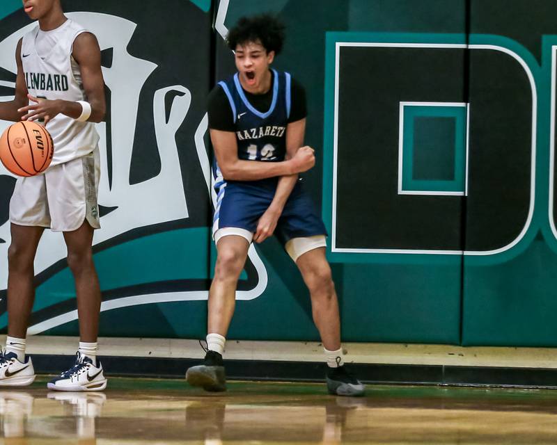 Nazareth's Rasim Johnson (12) reacts after scoring off of a breaak-a-way layup during their Jack Tosh Holiday Classic basketball tournament game between Nazareth vs Glenbard West. Thursday Dec 26, 2024 in Elmhurst.