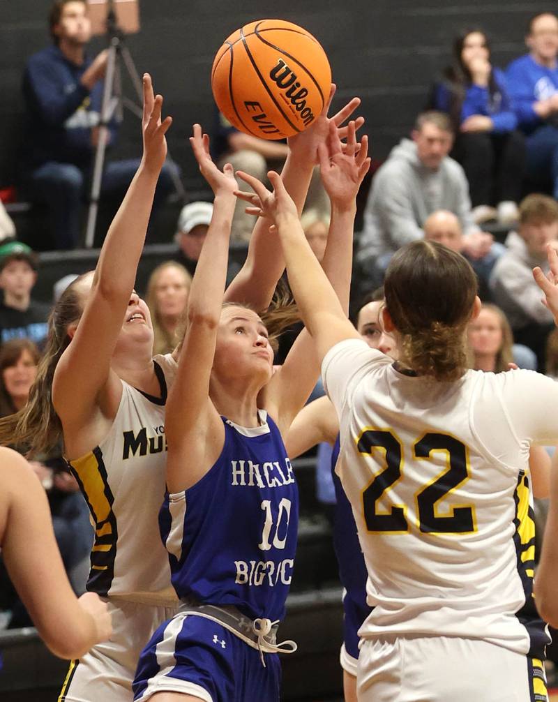 Hinckley-Big Rock's Grace Michaels goes after a rebound between Yorkville Christian's Payton Wallin (left) and Danielle Bulson during their Class 1A regional game Tuesday, Feb. 17, 2025, at Indian Creek High School in Shabbona.