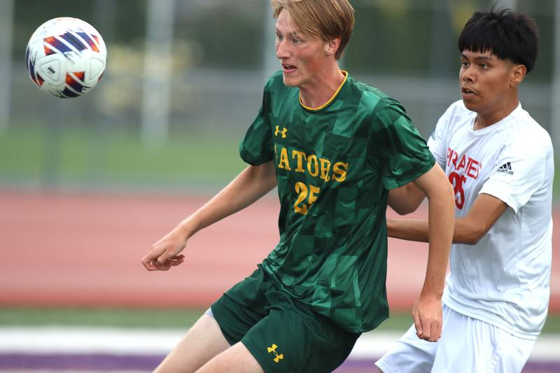 Crystal Lake South’s Seth Walker, center, races Palatine’s Colin Mielas in varsity boys soccer at Ray Porten Field on the campus of Wauconda High School in Wauconda on Wednesday, Sept. 3, 2025.