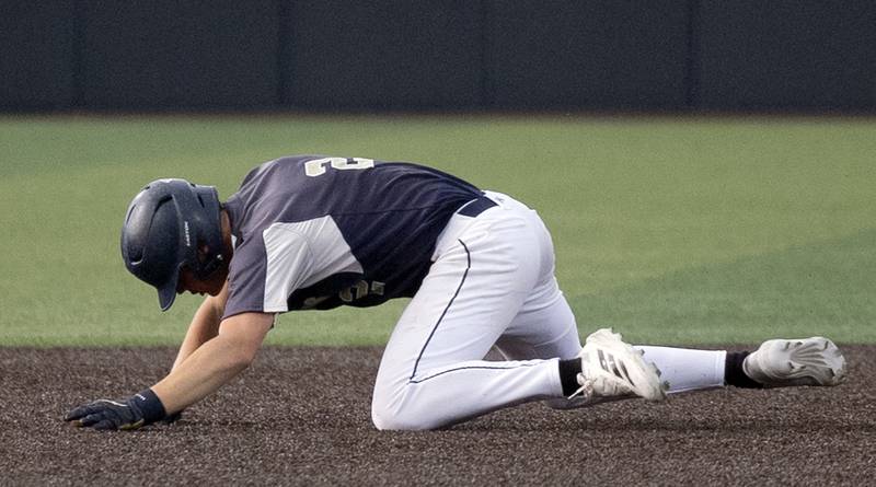 Teutopolis’ Davin Worman falls down rounding second against Newman Friday, June 6, 2025, during the Class 2A state semifinal at Illinois Field in Champaign.