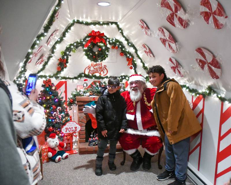Lorenzo Barrera, 12, and Ruben Barrera, 8, of DeKalb, pose for a photo during the DeKalb Chamber of Commerce's annual Lights on Lincoln and Santa Comes to Town event held in downtown DeKalb on Thursday, Nov. 30, 2023.