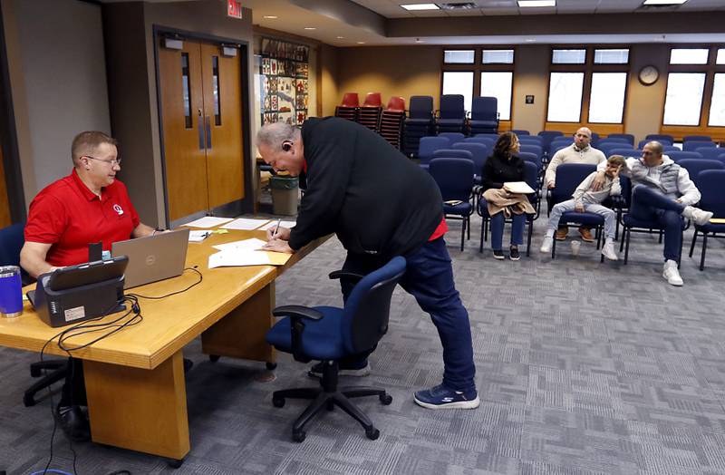 Chris Moore files his paperwork Tuesday, Nov. 12, 2024, to run for Ward 5 alderman with McHenry Deputy Clerk Monte Johnson during first day of filing for the consolidated election on April 1, 2025.