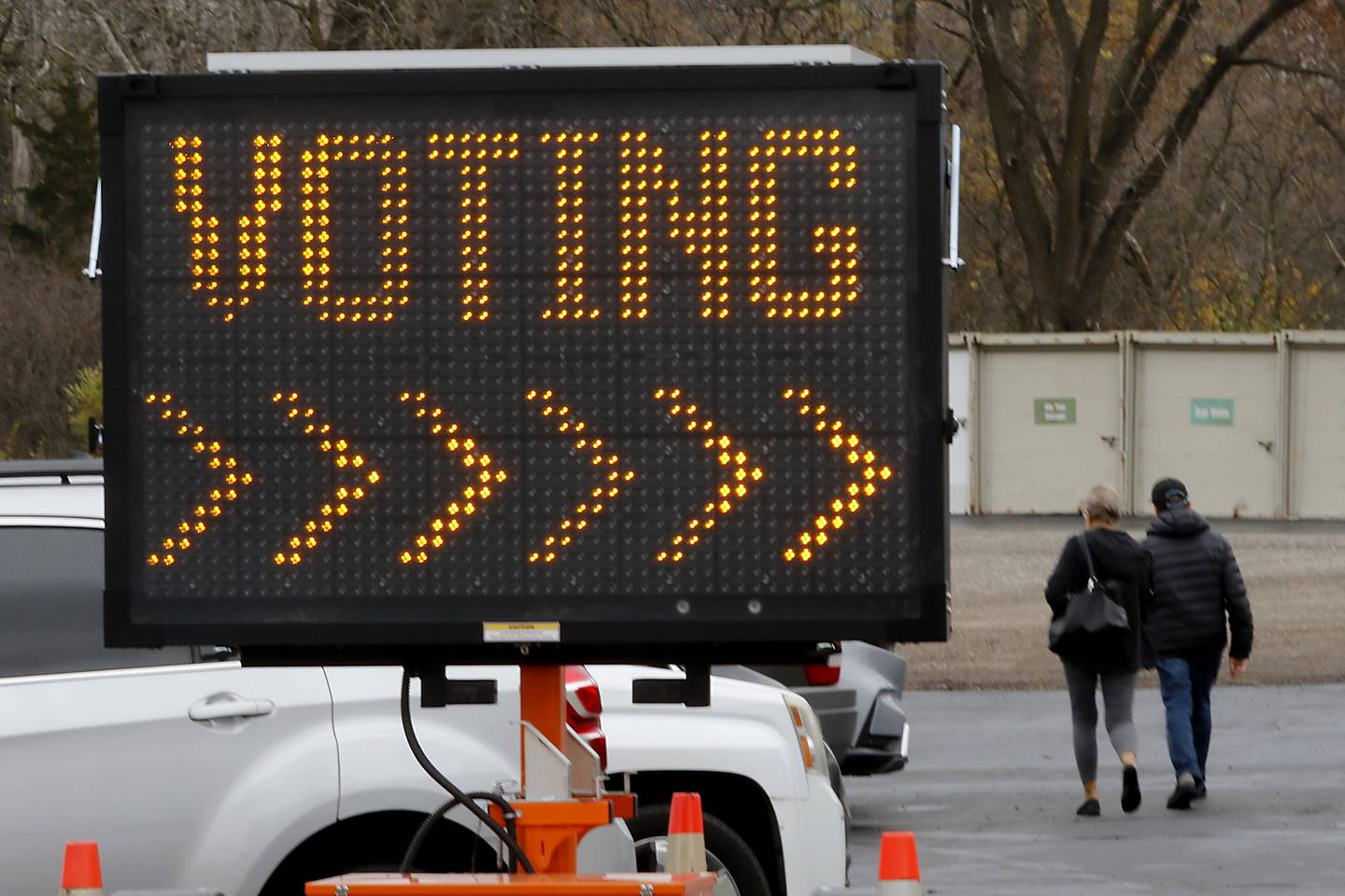 A couple walks through the parking lot on Monday, Nov. 4, 2024, after voting at tthe Algonquin Township Office at 3702 US Hwy 14, in Crystal Lake.