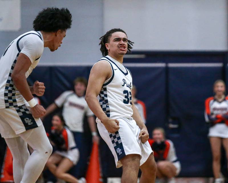 Oswego East's Alton Bullock (32) reacts after hitting a three pointer to force overtime during their basketball game between Oswego at Oswego East, Feb 13, 2026 in Oswego.