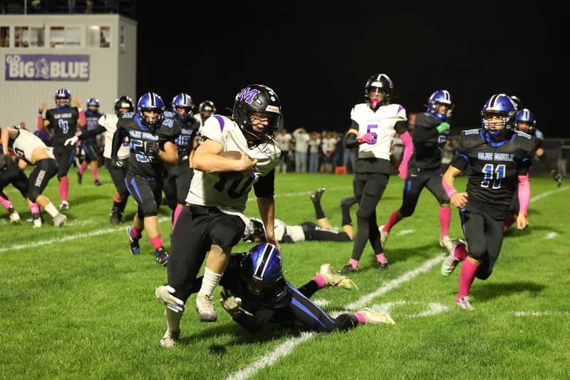 Manteno's Connor Harrod runs the ball as Peotone's Nick Cronin makes the tackle during the Panthers' 25-20 victory over Peotone on Friday, Oct. 17, 2025, in the annual Rumble on Route 50 rivalry game.