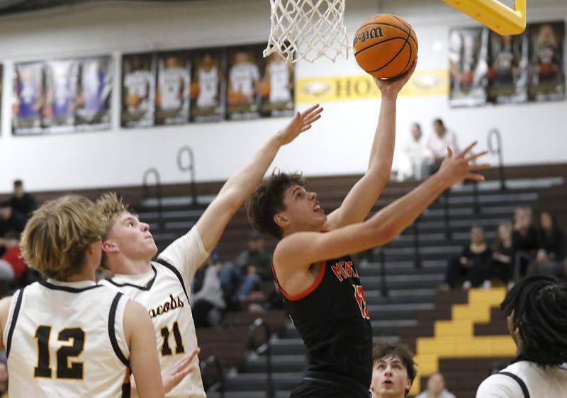McHenry's Caleb Jett drives tot eh basket against Jacobs' Carson Goehring during a Fox Valley Conference basketball game on Friday, Jan. 24, 2025, at Jacobs' High School.
