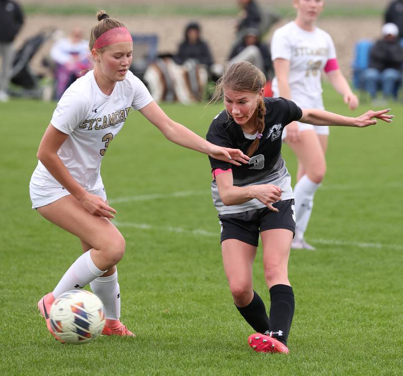 Kaneland's Zoe Gannon (right) kicks the ball by Sycamore's Marin Gautcher Wednesday, April 30, 2025, during their game at Kaneland High School in Maple Park.