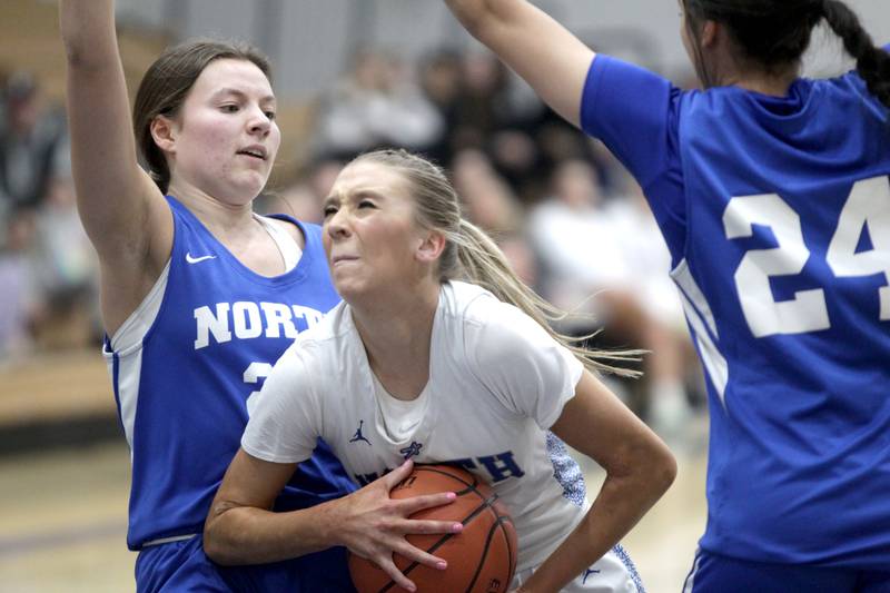 St. Charles North’s Reagan Sipla (center gets through Wheaton North defenders Mira Spillane (left) and Sara Abdul (left) during the Class 4A St. Charles North Regional final on Thursday, Feb. 16, 2023.