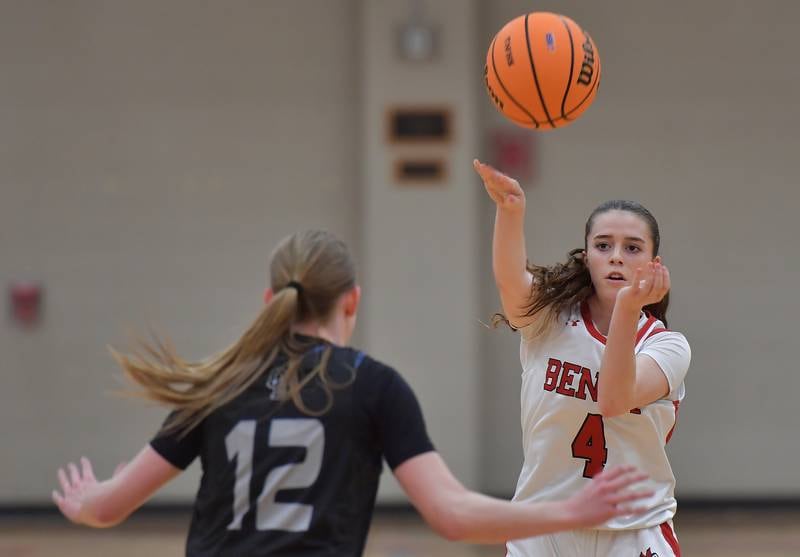 Back from an injury Benet point guard Ava Mersinger (4) fires a pass over Oswego East’s Nicole Warbinski during the Class 4A Benet Regional final on February 19, 2026 at Benet Academy in Lisle.