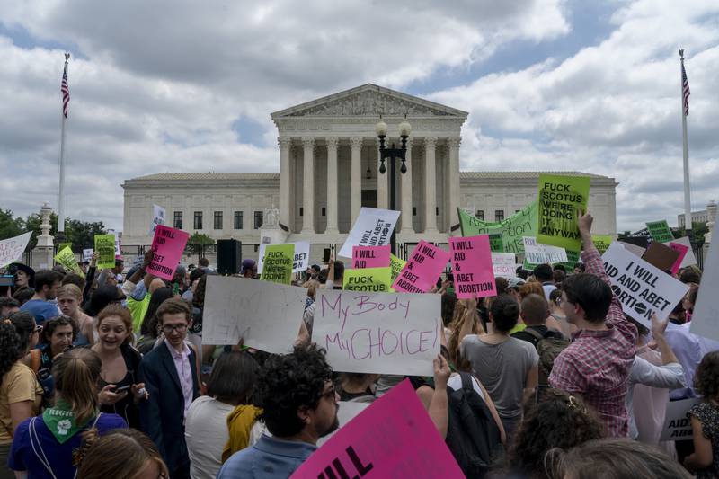 Abortion-rights protesters regroup and protest following Supreme Court's decision to overturn Roe v. Wade, federally protected right to abortion, in Washington, Friday, June 24, 2022. The Supreme Court has ended constitutional protections for abortion that had been in place nearly 50 years, a decision by its conservative majority to overturn the court's landmark abortion cases. (AP Photo/Gemunu Amarasinghe)