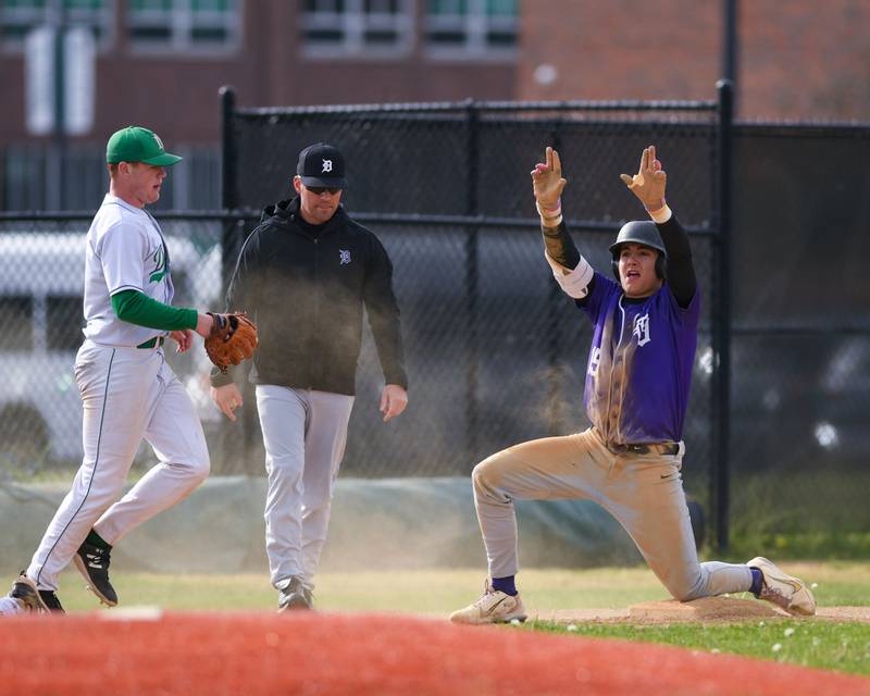Downers Grove North's Brady Schallmoser, right, celebrates his triple during the game on Monday May 19, 2025, while taking on York High School in Elmhurst.