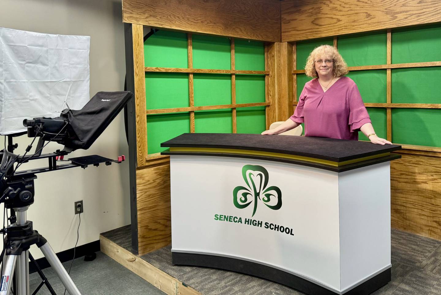 Marilee Applebee sits at the broadcast journalism desk in her classroom at Seneca High School. Over her 34-year career, Applebee taught multiple courses including AP English, Holocaust literature and broadcast journalism, leaving an impact on hundreds of students.