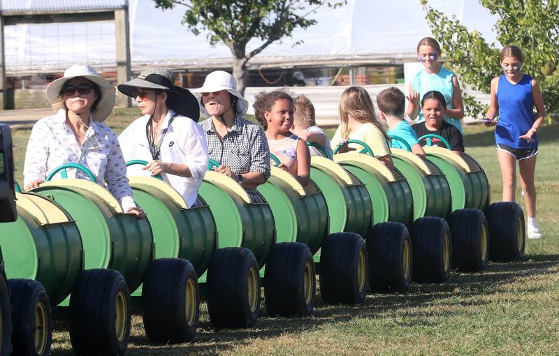 People enjoy riding the barrel buckets during the 26th Annual Pumpkin Harvest Craft Show. at Boggios Orchard and Produce on Saturday, Sept. 27, 2025 in Granville. This weekend featured the craft show, market, bakery, and pumpkin hill free of charge. There is a cost to take the kids to the play area which includes a jumping pillow, corn maze, wagon rides, a petting zoo, and playground.