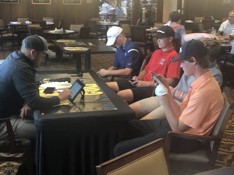 Hall's Grant Plym reports to the scorer's table at TPC Deere Run Monday.