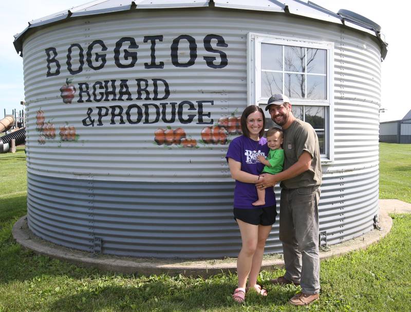 Joe and Christine Migliorini pose with their son Geo at Boggios Orchard and Produce on Wednesday, July 19, 2023 in Granville. The couple bought the orchard this year from Keith and Denise Boggio after 30 years of opperation. Joe is a nephew of Keith and Denise. He, along with his wife, look forward to keeping the operation in the Boggio family while continuing to provide the same great experience that Keith, Denise, and their family have worked hard to build and you have grown to love.