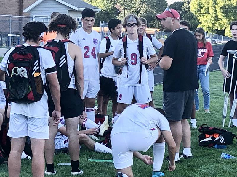 Streator coach JT Huey talks to the Bulldogs after Monday's 5-0 win a Princeton in their season opener.