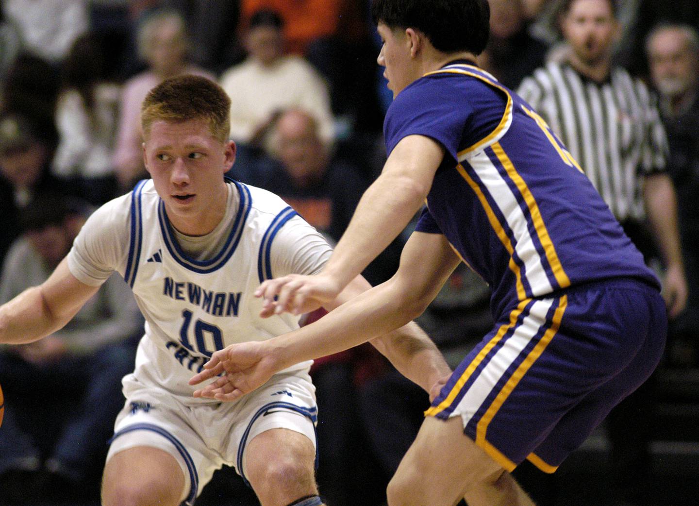 Newman's George Jungerman looks to pass the ball as Mendota's Oliver Munoz defends. The Newman Comets defeated the Mendota Trojans 67-66 at Newman High School in Sterling. The game took place on Tuesday, January 13, 2025.