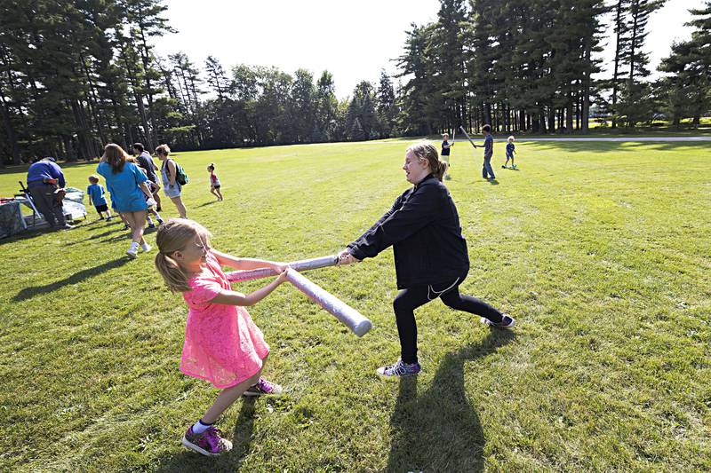 Coraline Jones, 9, and sister Zoey, 12, stand locked in an epic sword battle Saturday, Sept. 23, 2023 at Lowell Park. The two were sampling the weapons provided by the CER LARP group.
