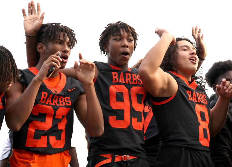 DeKalb High School football players have a good time as they head down Dresser Road Wednesday, Sept. 27, 2023, during the homecoming parade.