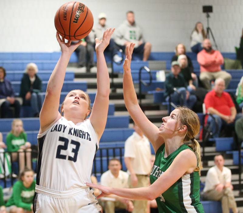 Fieldcrest's Riley Burton shoots a shot over Eureka's Ellie Cahill on Monday, Jan. 9, 2023 at Fieldcrest High School.