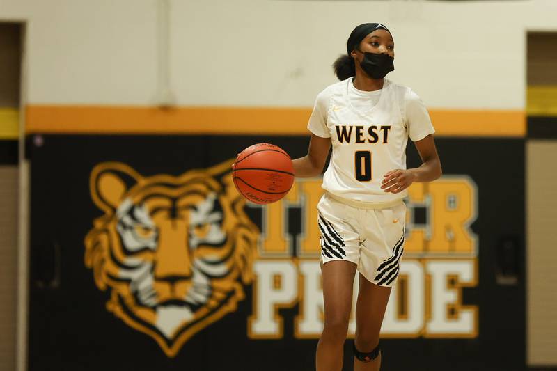 Joliet West’s Lisa Thompson works the ball up court against Joliet Central. Tuesday, Feb. 8, 2022, in Joliet.
