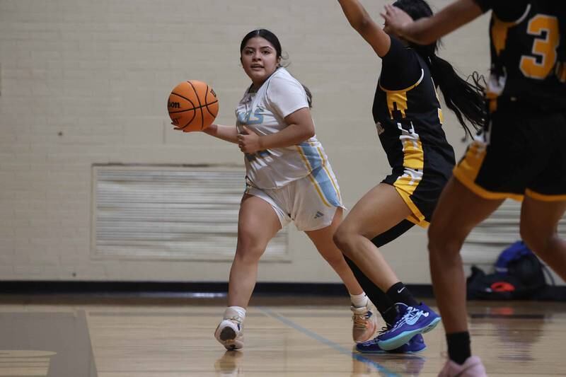 Joliet Catholic’s Breanna Zafra looks to pass against Marian Catholic on Monday, Dec. 9, 2024 in Joliet.