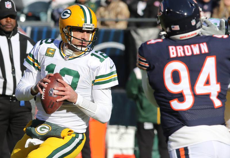 Green Bay Packers quarterback Aaron Rodgers looks for a receiver as Andrew Brown tries to get pressure during their game Sunday, Dec. 4, 2022, at Soldier Field in Chicago.