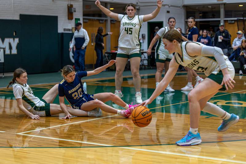 Lili McClain (23) of St. Bede recovers ball after Kaitlyn Davis (20) of Marquette hits screener Parker McClain (21) of St. Bede knocking them both to the floor on Friday, January 16, 2026 at St. Bede Academy in Peru.