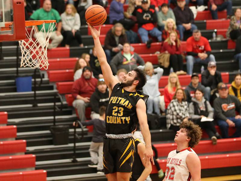 Putnam County's Jackson McDonald (23) runs past Hall's Payton Dye (32) to score a basket during the Colmone Classic on Tuesday, Dec. 6, 2022 at Hall Hight School in Spring Valley.