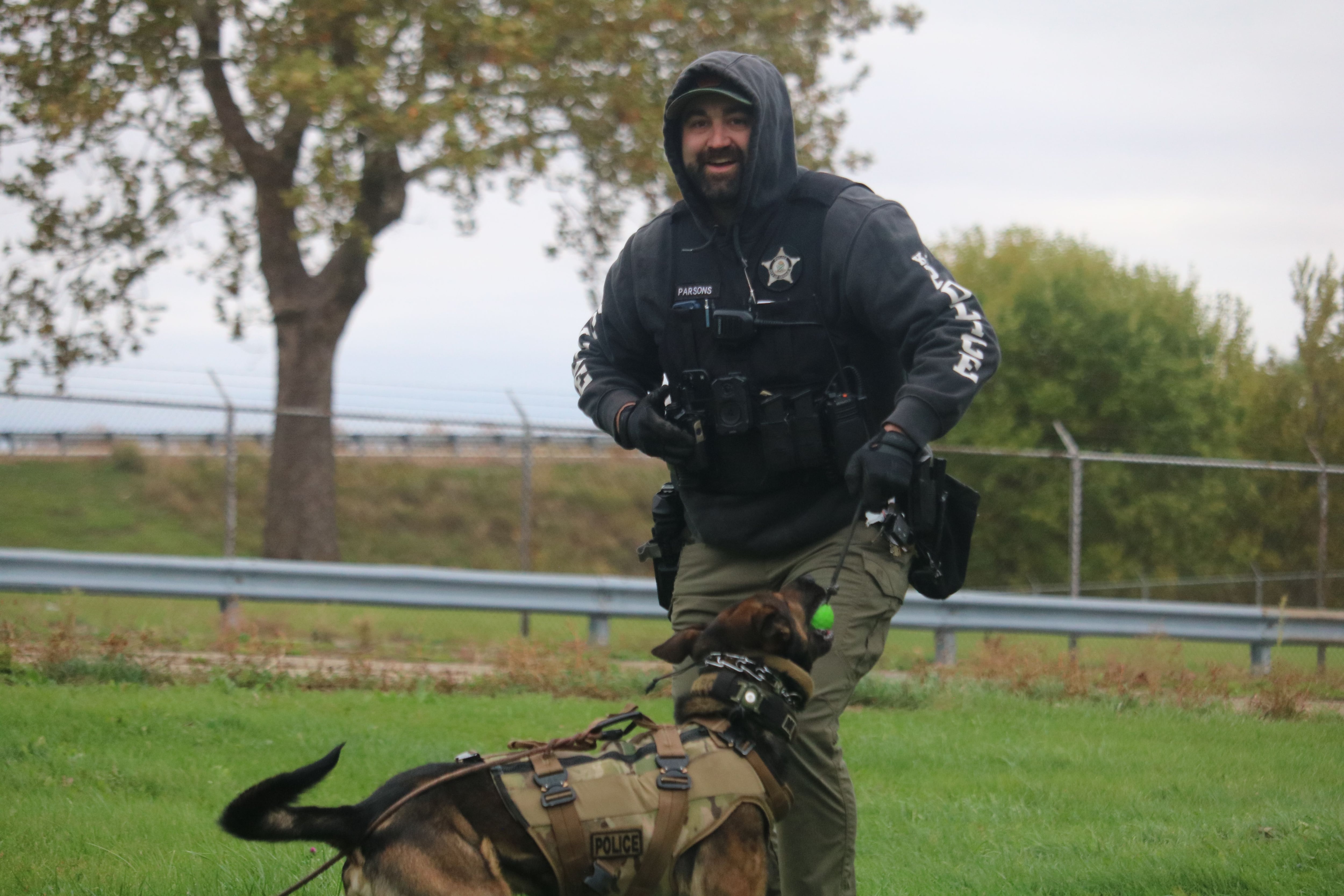 DeKalb police Sgt. Steve Parsons (left) is seen celebrating with Chase Oct. 22, 2025,   after a successful training sequence outside the former GE plant in DeKalb.