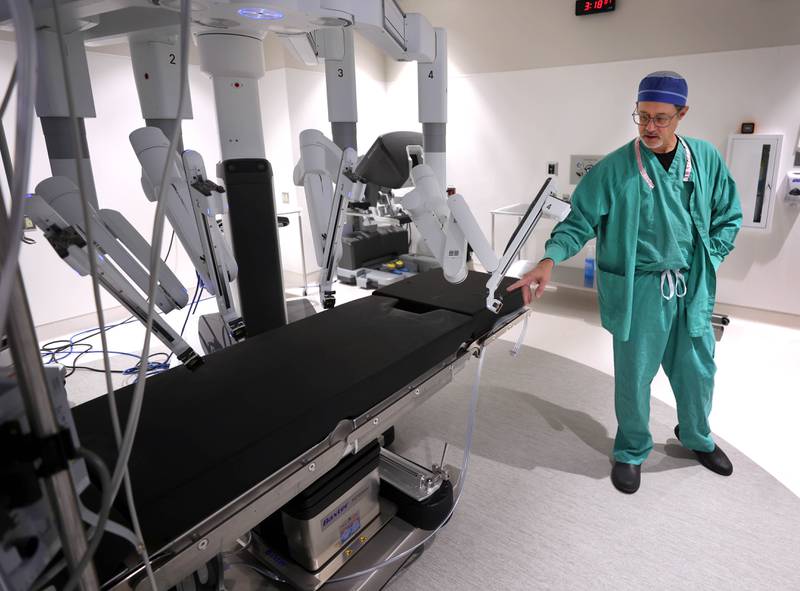 Dr. Jack Wagoner, associate chief medical officer at Northwestern Medicine Kishwaukee Hospital, talks about one of the arms of the da Vinci Xi robotic surgical system Tuesday, Oct. 28, 2025, in one of the operating rooms at the hospital in DeKalb. The hospital recently celebrated its 2,000th successful robotic-assisted surgery.