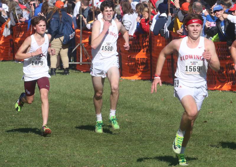 Prairie Ridge's Kieran Gilleland, Benet Academy's Matt Spellman and teammate Ryan Amidei compete in the Class 2A State Cross Country race on Saturday, Nov. 4, 2023 at Detweiller Park in Peoria.