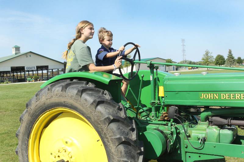 Emma McMillon, of Trevor, Wis., gives a ride to Tommy Maksymec, 5, of Hawthorn Woods on a 1941 John Deere B tractor during the Lake County Farm Heritage & Harvest Festival at the Lake County Fairgrounds on September 23rd in Grayslake. The festival was sponsored by the Lake County Farm Heritage Association.
Photo by Candace H. Johnson for Shaw Local News Network