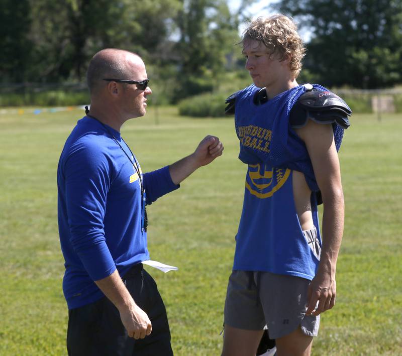 Johnsburg Head Coach Sam Lesniak talks with Ryan Larsen during summer football practice Thursday, June 23, 2022, at Johnsburg High School in Johnsburg.