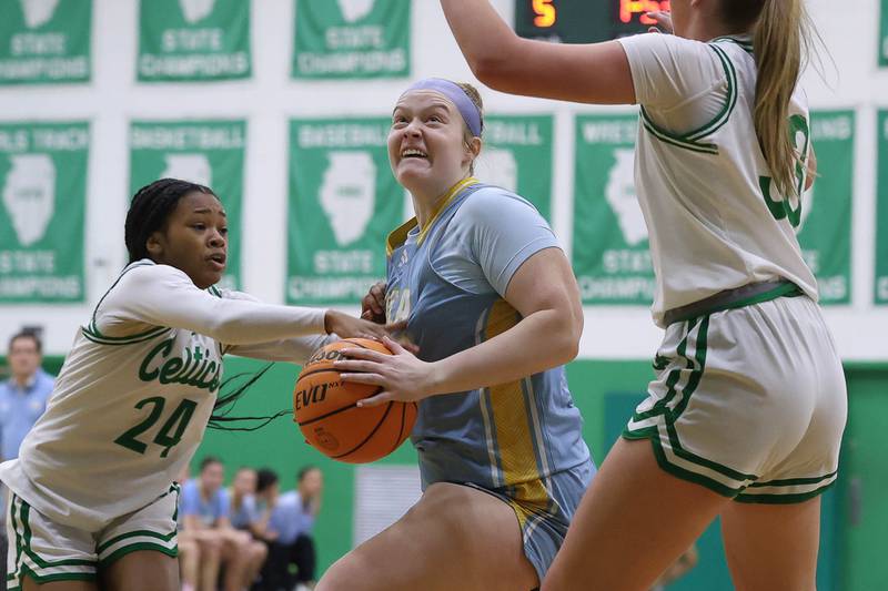 Joliet Catholic’s Emma Birsa draws the foul driving to the basket against Providence on Saturday, Dec. 5, 2025 in New Lenox.