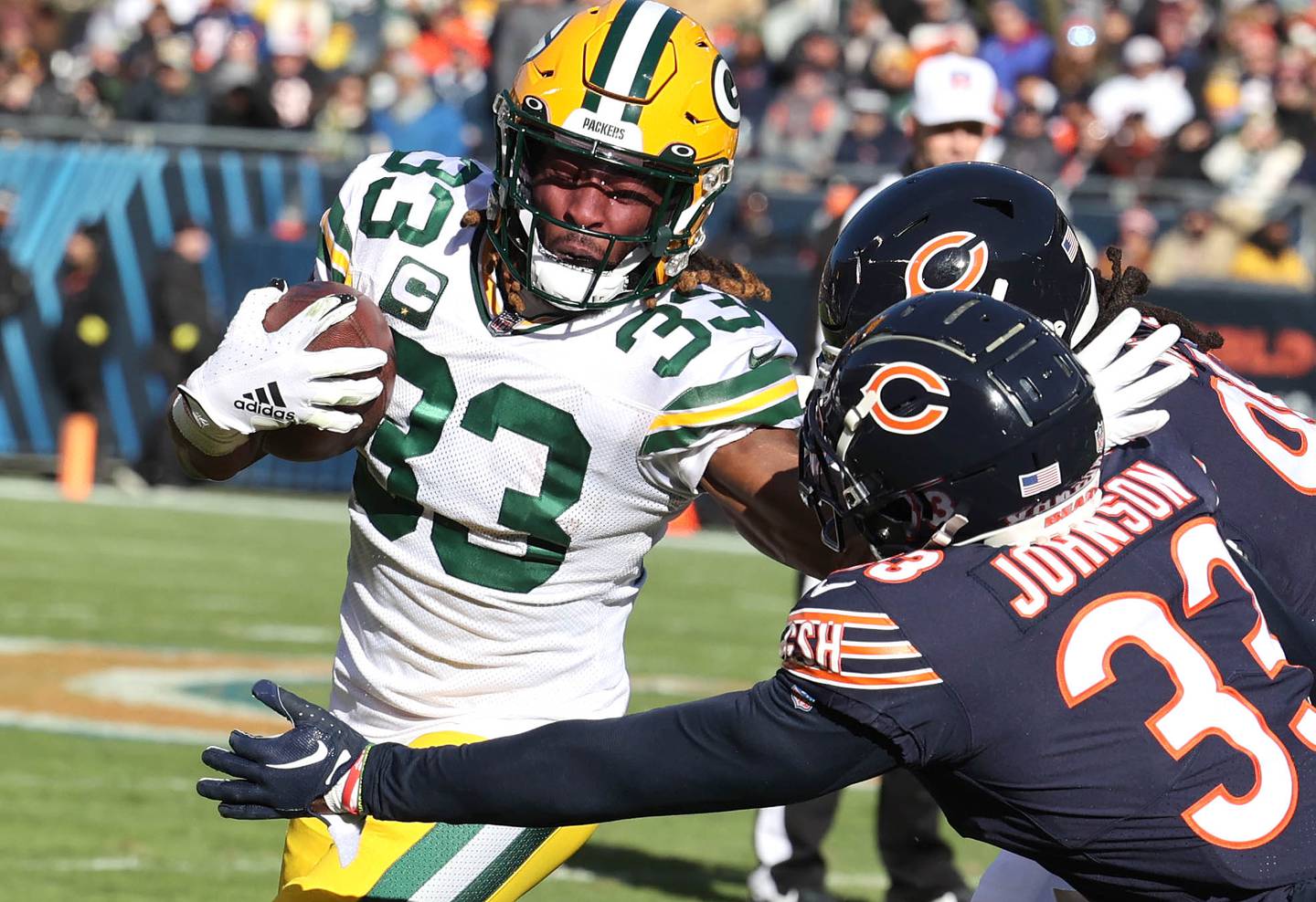 Green Bay Packers running back Aaron Jones tries to get by Chicago Bears cornerback Jaylon Johnson during their game Sunday, Dec. 4, 2022, at Soldier Field in Chicago.
