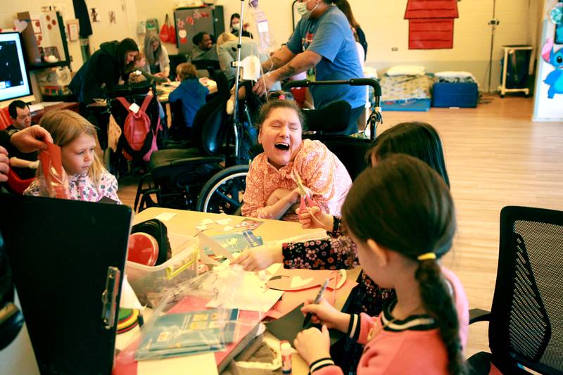 Marklund Hyde Center resident Theresa watches as students from Grace McWayne Elementary School make Valentines on Wednesday, Feb. 7, 2024.