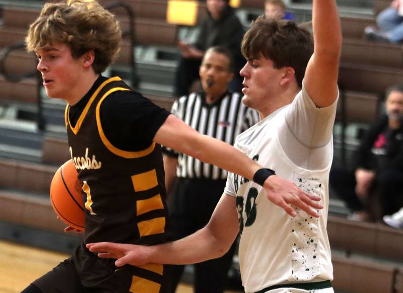 Jacobs’ Jack Magee, left, scoots past Grayslake Central’s Cole Halverson in varsity boys basketball Hinkle Holiday Classic action on Tuesday, Dec. 23, 2025, at Jacobs High School in Algonquin.