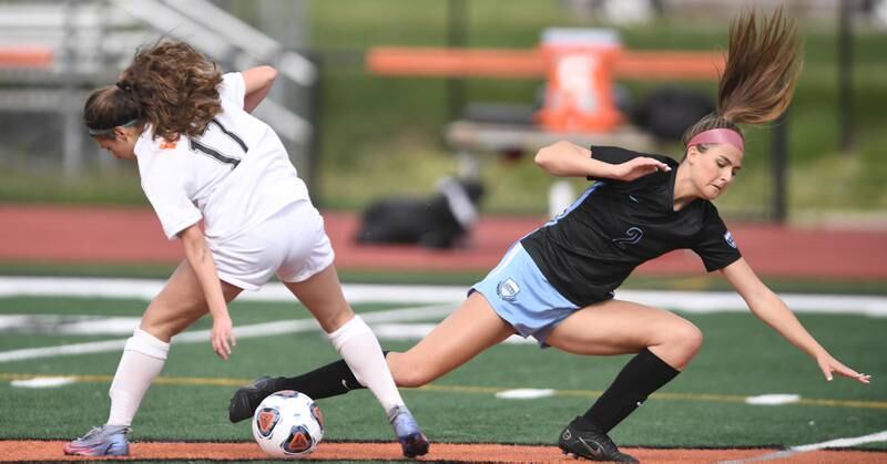 John Starks/jstarks@dailyherald.com
St. Charles North’s Kayla Floyd falls as she tangles with Wheaton Warrenville South’s Lily Petrie, left, in the St. Charles East girls soccer sectional semifinal game on Tuesday, May 24, 2022.