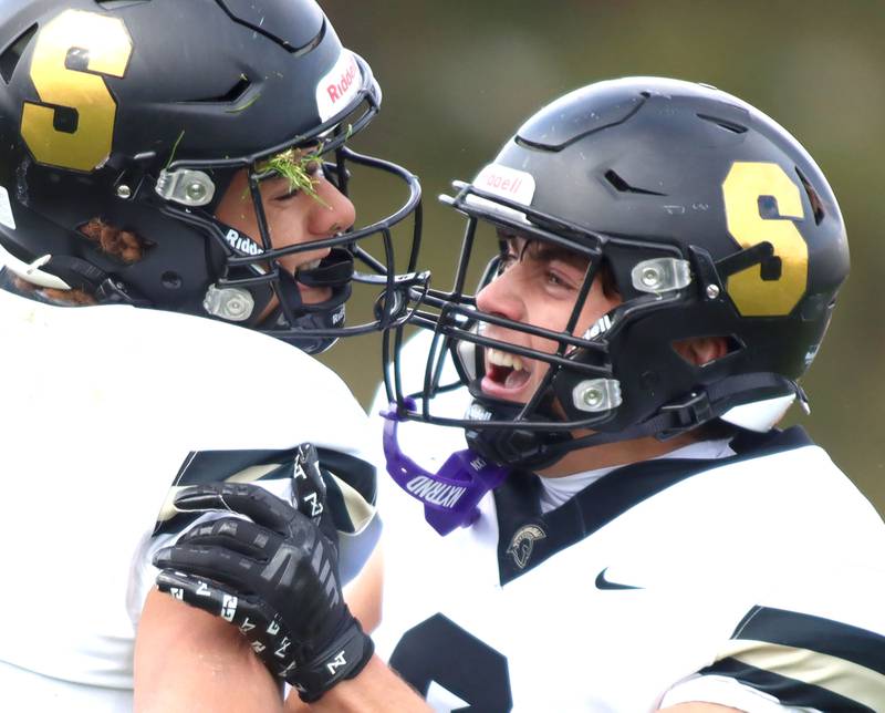 Sycamore’s Josiah Mitchell, left, is greeted by Benjamin Anderson after a Mitchell touchdown in IHSA football Class 5A first-round playoff action at Al Bohrer Field on the campus of Cary-Grove High School in Cary on Saturday, November 1, 2025.