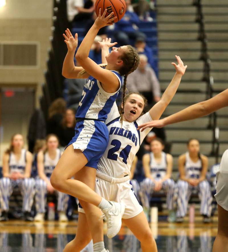 Wheaton North’s Mira Spillane shoots the ball over Geneva’s Kinsey Gracey during a game at Geneva on Friday, Dec. 22, 2023.