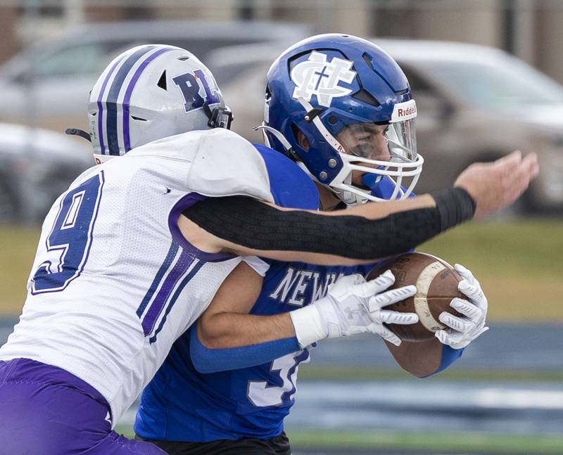 Newman’s Danny Welty picks up yards against Ridgeview-Lexington’s Joe Cheever Saturday, Nov. 1, 2025, in round one of the Class 2A football playoffs.