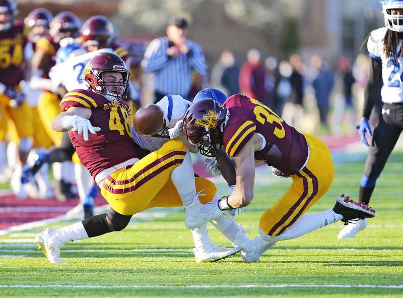 Loyola Academy's Jack Craddock (48) strips the ball from Phillips Academy's Marcus Puller during a 4th quarter play as the Phillips Academy Wildcats faced the Loyola Academy Ramblers on Friday, April 16, 2021 in Wilmette, IL. Loyola won 30-0.