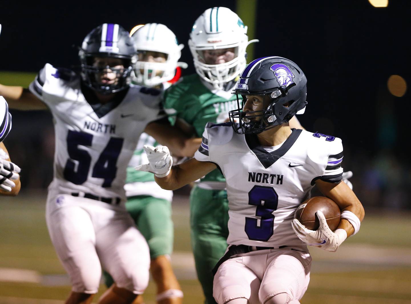 Downers Grove North's Ethan Thulin (3) runs back a kick during the boys varsity football game between Downers Grove North and York on Friday, Sept. 16, 2022 in Elmhurst, IL.