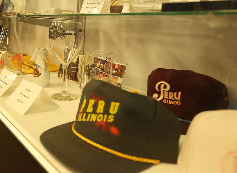 A view of vintage photos in a display case on Tuesday, March 31, 2026 at the Peru City Hall. The Peru Historical Society has collected the memorabilia. They are looking for items to donate to the growing collection. The group meets the last Tuesday of each month inside Peru City Hall at 6:30p.m.