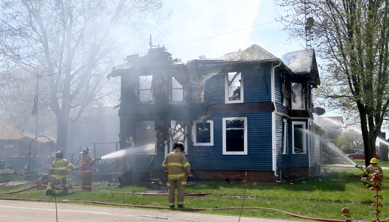 Firefighters from Paw Paw, Somonauk, Troy Grove, Mendota, Earlville, Leland, Utica and Ottawa work the scene of a house fire in the 300 block of Maple Street on Monday, April 22, 2024 in Earlville. The fire happened around 10a.m.