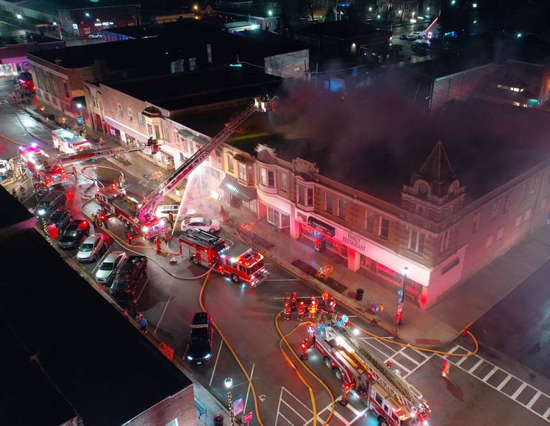 Firefighters battle an apartment fire in the second story at 708 Illinois Avenue on Friday, Dec. 30, 2022 downtown Mendota.