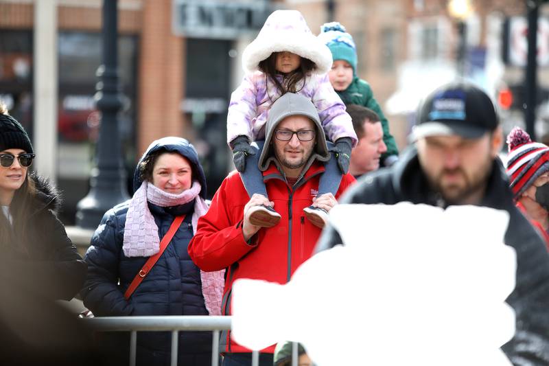 Monica and David Gee of Downers Grove and their daughter, Julia, 3, watch as Jack Neiweem of Nadeau’s Ice Sculptures carves a sea horse out of a block of ice during the Downtown Downers Grove Ice Festival on Saturday, Feb. 1, 2025 in Downers Grove.